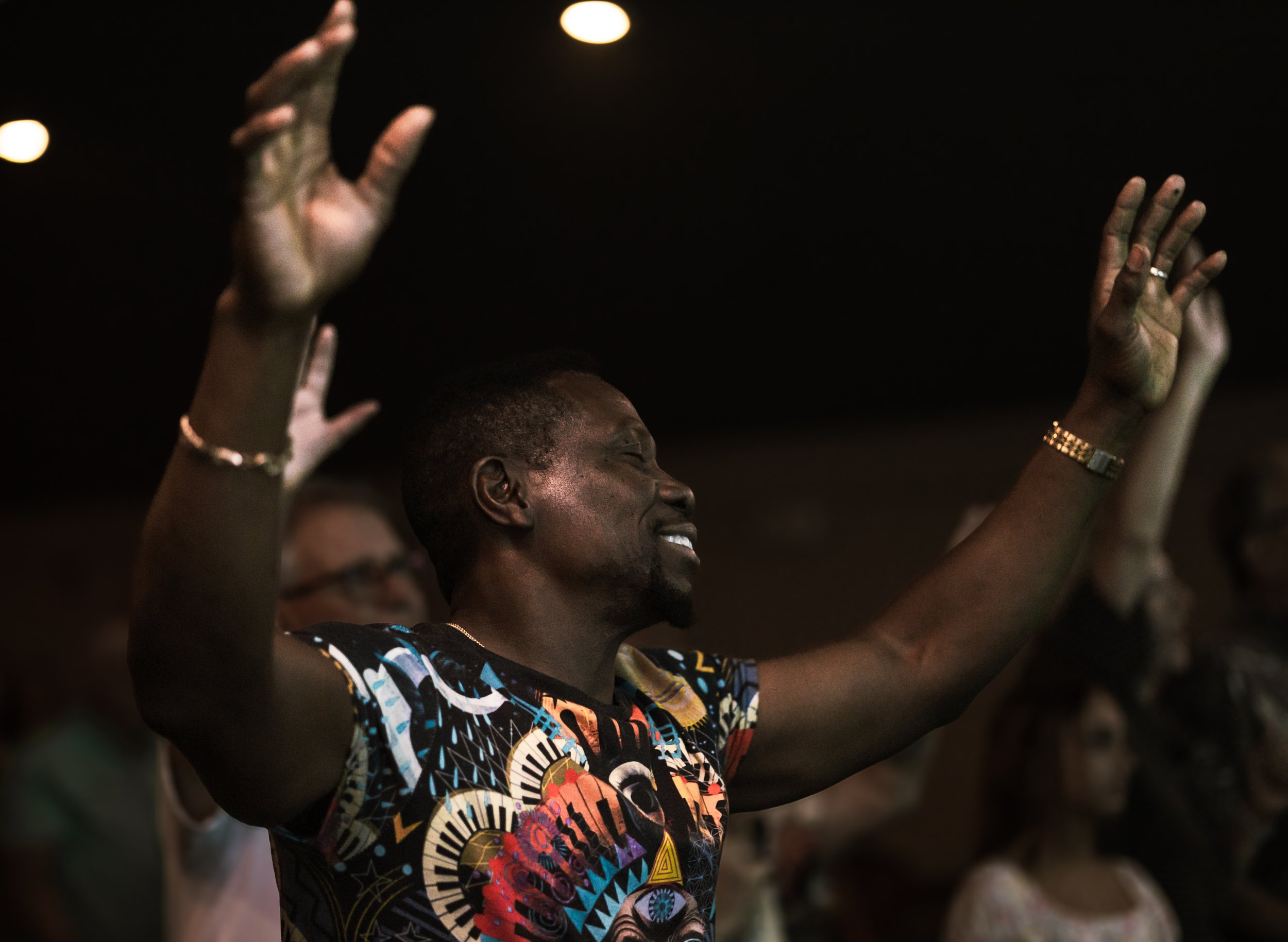 Man worshipping with arms raised